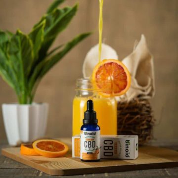 Binoid Water-Soluble CBD Drops-Orange box and bottle with drink